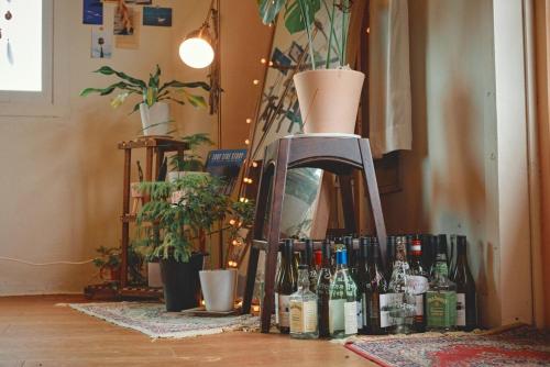 a group of bottles of wine sitting on a floor at Jeju Hadoya Beer N Bed in Jeju