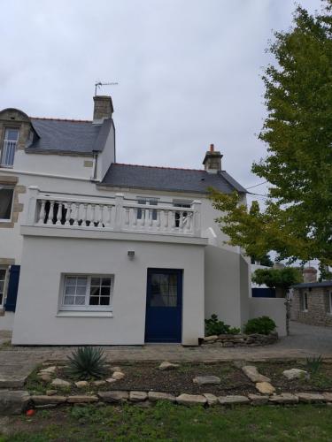 a white house with a balcony on top of it at MANOIR ST YVES -Gîte in Quiberon
