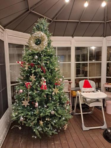 a christmas tree is in a room with a table at Kyeongju Withbebe Dockchae Kids Poolvilla in Chŏngnae-dong