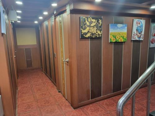 a hallway with wooden doors and paintings on the wall at Sillim Flower in Seoul