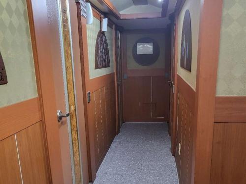 a hallway of a train with wooden doors at Sillim Flower in Seoul