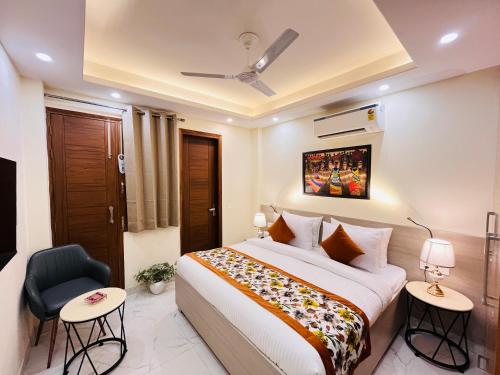 a hotel room with a bed and a chair at Hotel Ivaan Homes opposite to Iskcon Temple East of Kailash New Delhi in New Delhi