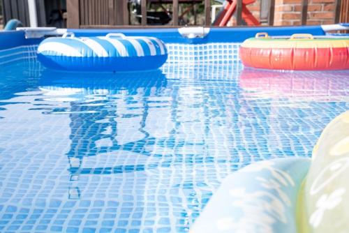 a swimming pool with two inflatables in the water at Jeju Dumo 542 in Jeju