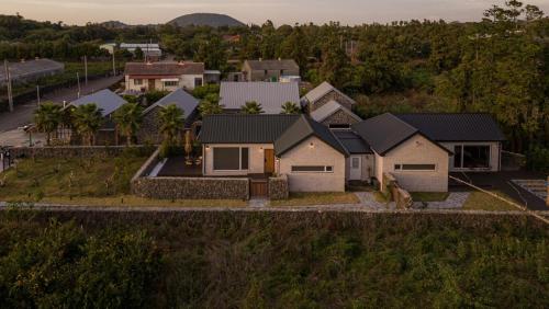 an aerial view of a house with a driveway at Jeju Cheongsu-ri Haru Private Pension in P'yŏnghwa-dong