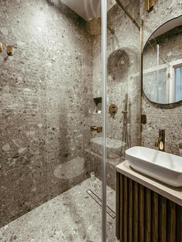 a bathroom with a sink and a shower at Apartament Lipowa Centrum in Białystok
