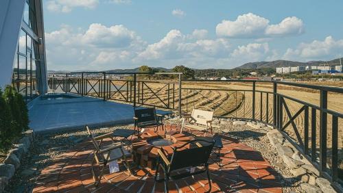 a patio with a table and chairs on a balcony at Gyeongju Stay Sosori in Gyeongju