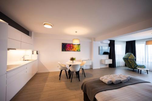 a bedroom with a bed and a table and chairs at Lounge 8 Studios in Oradea
