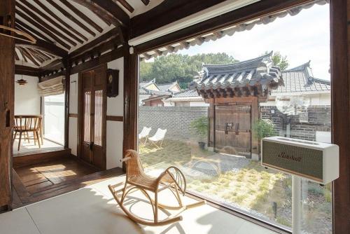 a chair sitting on a porch with a large window at Jeonju Leisure in Jeonju