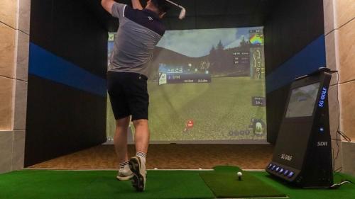 a man is playing a video game on a screen at Seosan View Live in Seosan