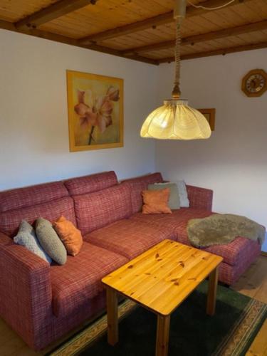 a living room with a couch and a table at Bärenhof Backhaus in Eisenbach