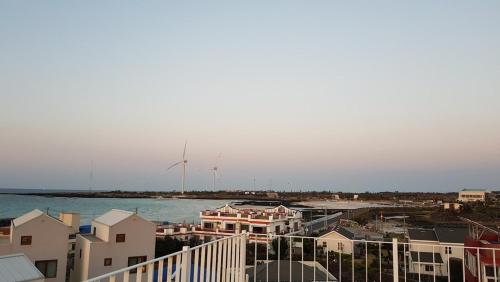 a view of a city with wind turbines in the distance at Jeju Viento Gimnyeong Pension in Jeju