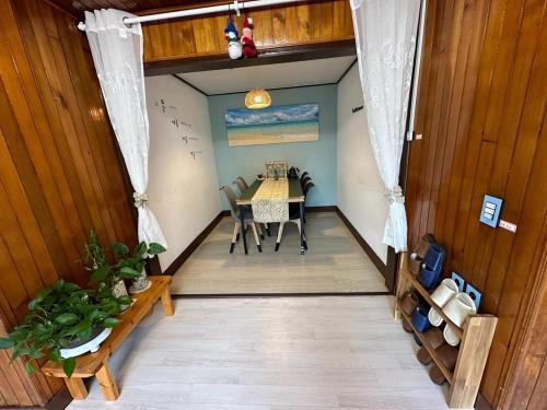 a dining room with a table and chairs in a room at Namhae Audrey House in Namhae