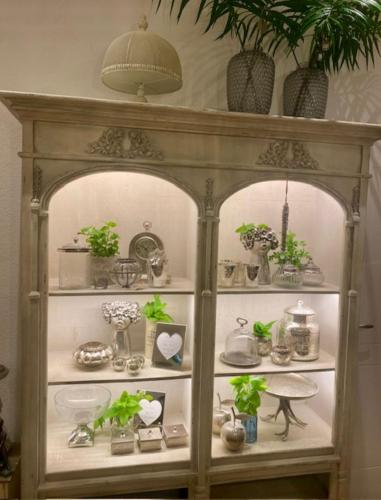a shelf filled with lots of plants and vases at Gästehaus Weiherhof in Alpbach