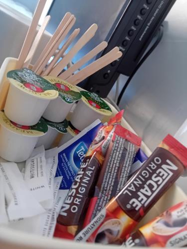 a bowl filled with food and chopsticks and snacks at Wishing Well Guest House in Blackpool