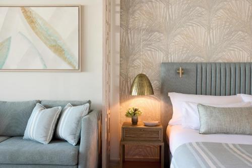 a bedroom with a bed and a couch and a picture at Porto Sani in Sani Beach