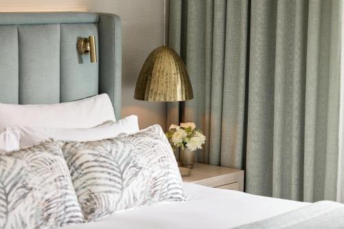 a bedroom with a bed and a lamp and curtains at Porto Sani in Sani Beach