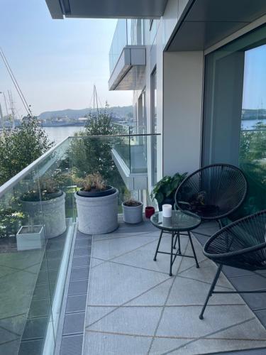 a balcony with a table and chairs on a building at Apartament Faltom 6 Yacht Park Premium in Gdynia
