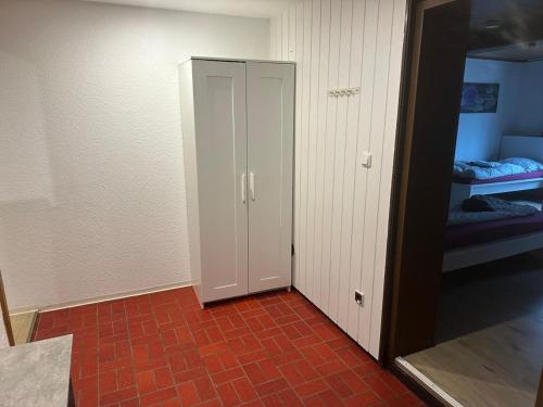 a room with a door and a room with a bedroom at Work&Stay Apartments Hellenthal in Hellenthal