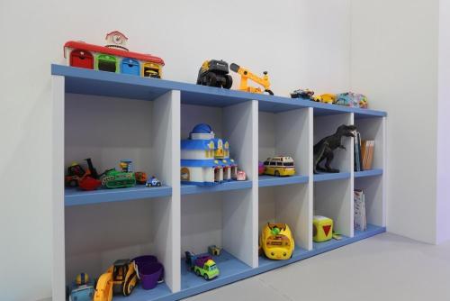 a toy shelf with blue shelves with toys on them at Geoje Haewanaru Youthtel in Geoje 