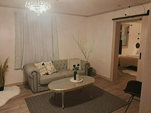 a living room with a couch and a table at Dream Pension in Yeongdeok