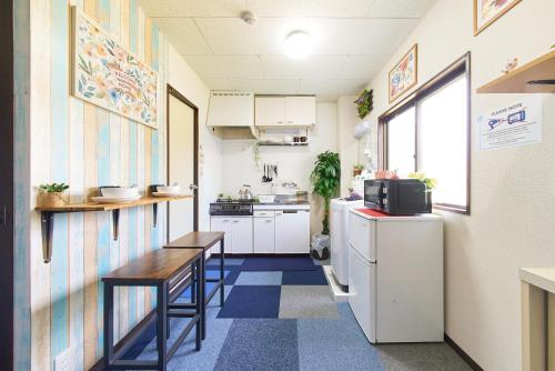 a small kitchen with a table and a counter at Belmont 203 3min to Station Easy Access Ueno Asakusa Skytree Sleeps 4 in Tokyo