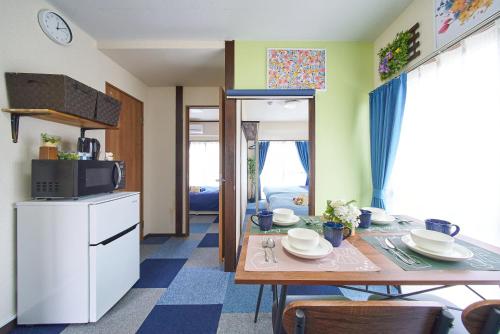 a small kitchen with a table and a microwave at Belmont 301 3min to Station Easy Access Ueno Asakusa Skytree Sleeps 5 in Tokyo
