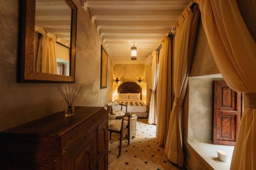 a bedroom with a bed and a dresser in a room at Riad Senja in Marrakech