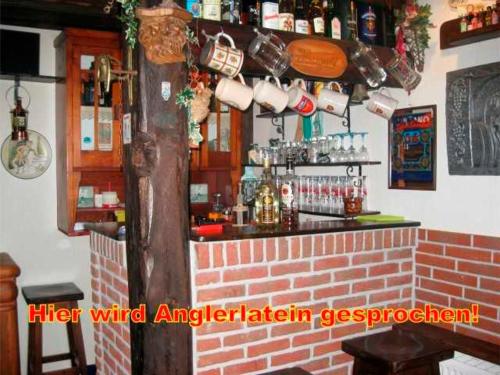 a bar in a restaurant with a brick wall at Ferienwohnung Petri Heil - nur für Urlaubsgäste - 85059 in Ostrhauderfehn