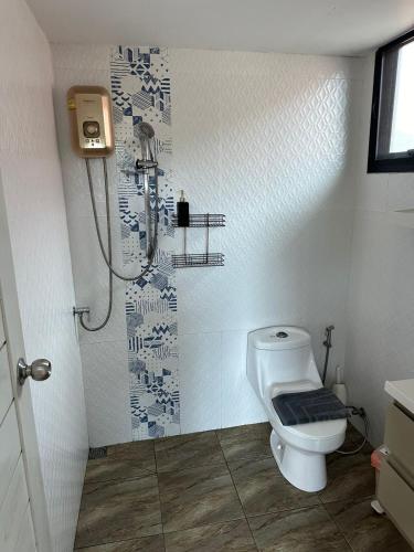 a bathroom with a toilet and a shower at Penthouse Crystal Bay Apartments in Ban Lamai