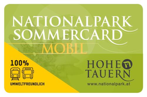 a sign for a national parkurrencyurrency module with a bus at Hotel Gasthof Kröll Nationalpark-Card, Bergbahnen, Großglockner, Restaurant mit regionaler Küche in Niedernsill