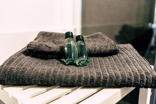 two glass bottles sitting on top of a towel at Studio Duria in Düren - Eifel