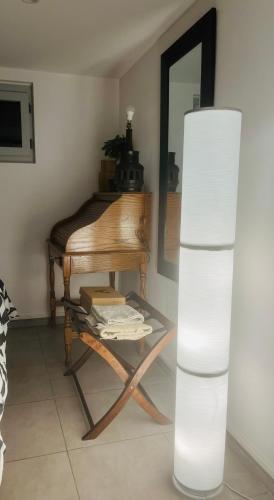 a room with a piano and a table with a mirror at Chic and Peaceful apartment Roissy Charles de Gaulle Airport 15mins-Parc des Expositions Villepinte 10mins- Disneyland 30mins in Tremblay En France