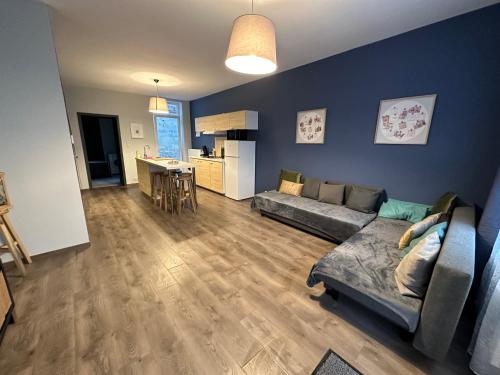 a living room with a couch and a kitchen at LFA - 167 - Agréable maison de village in Seraing