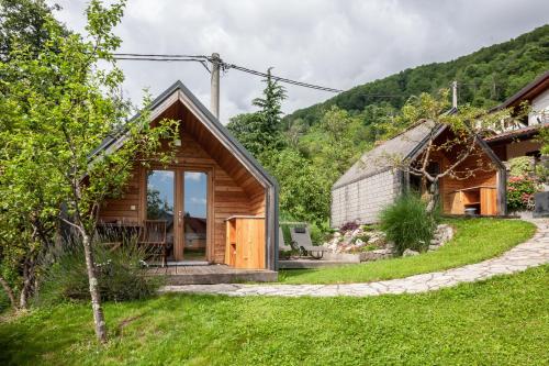 a small house in the middle of a yard at Glamping Kranjc in Kobarid
