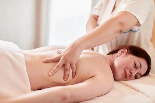 a woman getting a massage from a therapist at Iberostar Selection Kantaoui Bay in Port El Kantaoui
