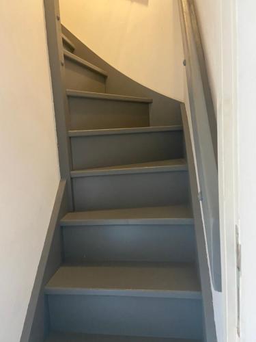a staircase with blue shelves in a house at b&b du Clos Ménil in Asnières-sur-Seine