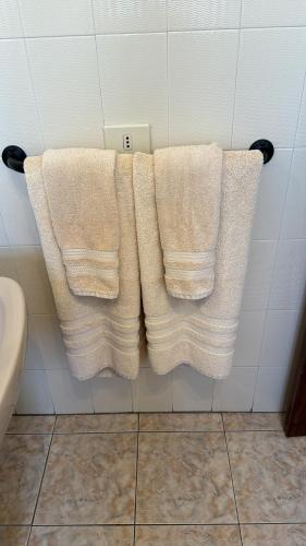 two white towels hanging on a wall in a bathroom at Azul 41 - Puerto Del Carmen Harbor with Oceanview, pet friendly, Pool in Tías