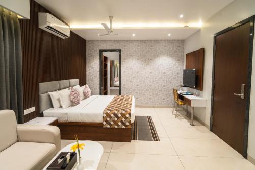 a bedroom with a bed and a living room at MGM Whispering Meadows Yelagiri in Yelagiri