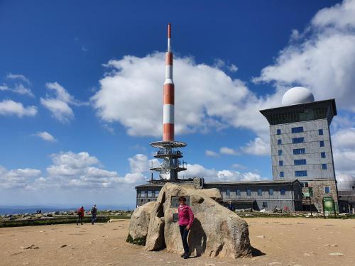 a woman standing next to a rock with a missile at ****FH Blauvogel 60 Harz in Hasselfelde