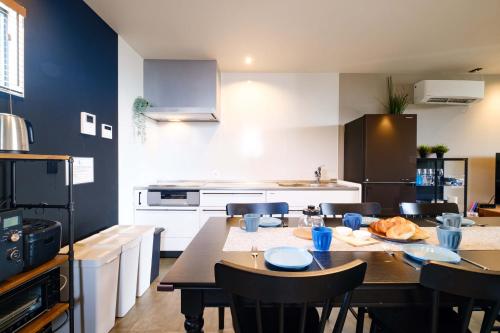 a kitchen with a table and chairs in a kitchen at Urban Resort Villa ILILANI in Inbu