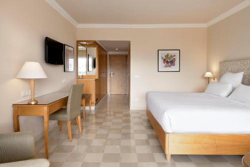 a hotel room with a bed and a desk at Iberostar Selection Kantaoui Bay in Port El Kantaoui