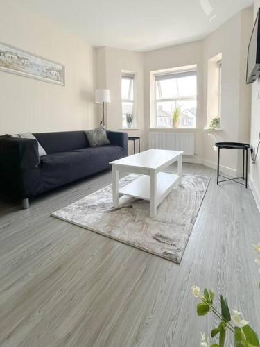 a living room with a couch and a white coffee table at Wellington Road Apartment 4 in Southtown