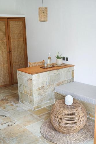 a room with a stone counter and a table at Villa Mimpi - Bela Sulu Villas in Katiet