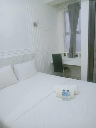 a bedroom with a bed and a desk and a chair at Apartemen transpark cibubur by parvez 2 in Kalimanggis