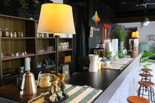 a table with a lamp on top of it at Puli Islet Inn in Puli