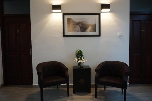 two chairs in a waiting room with a picture on the wall at The Villa In Lavinia in Mount Lavinia