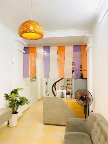 a living room with a couch and colorful curtains at Homestay May's house Lo Duc in Hanoi