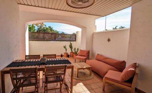 a living room with a couch and a table and chairs at Sea&Ski Oasis Apartment in Salobreña