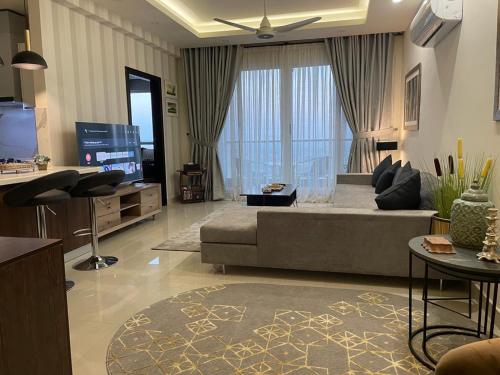a living room with a couch and a tv at 2 Bed Room Suite-Elysium Tower Opp Centaurus Mall Islamabad in Islamabad