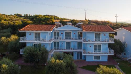 an aerial view of a large blue house at Filoxenia Apartments & Studios in Theologos